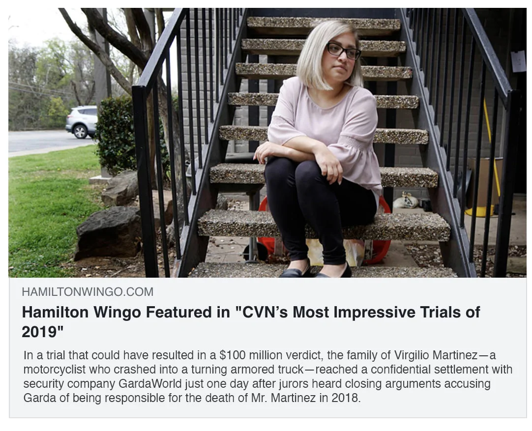 A lady sitting at the foot of a stone stairwell